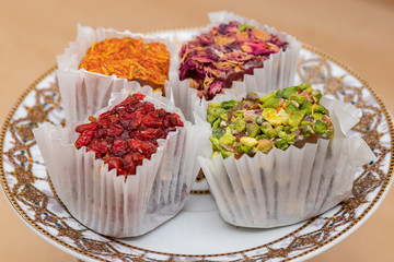 Four cubes of fruit delight of different tastes on a saucer, tra