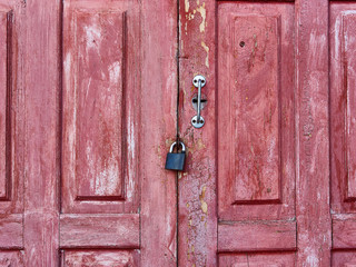 Old weathered barn doorwith with padlock