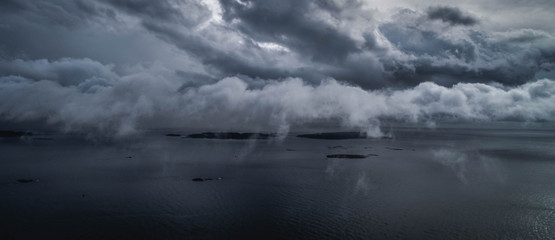 Fototapeta na wymiar Dark blue thunder clouds over ocean islands