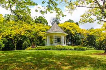 Fototapeta na wymiar Wooden house gazebo in the colorful tropical garden