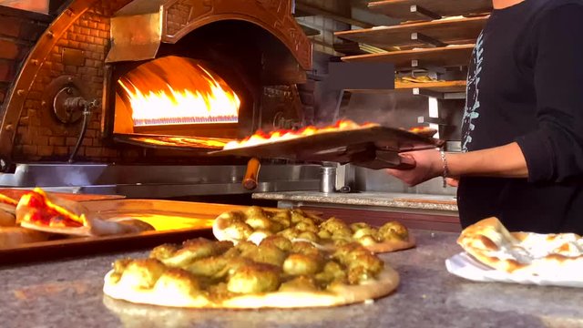 Manakeesh Lebanese breakfast Putting into the Hot Flaming Oven