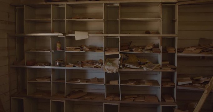 Old Book Shelves With Cluttered Books Covered In Dust And Dirt In An Abandoned House In Olary, Outback Australia