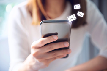 Email concept, Closeup Woman hand using mobile smartphone with email icon. - obrazy, fototapety, plakaty