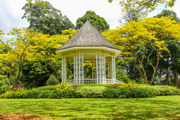 Wooden house gazebo in the colorful tropical garden