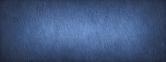Blue grunge background. Concrete wall surface texture with old rough stucco. Close-up. Blue banner with a rough texture for your design.