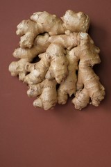 Ginger root close-up   on a  brown background. Organic bio healthy vegetables and spices.
