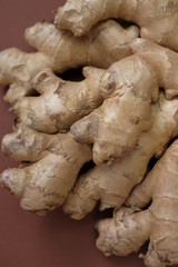 Ginger root close-up   on a  brown background. Organic bio healthy vegetables and spices.