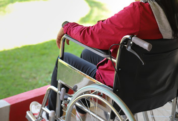 Closeup of a woman patient sitting in wheelchair at the O.P.D. of hospital.