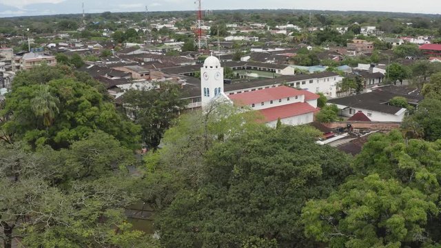 Church in the town of San Martín / Colombia, with vegetation close to the population, Catholic belief, Aerial drone video.