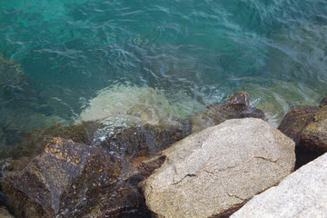 Waves hitting the rocks in the beach