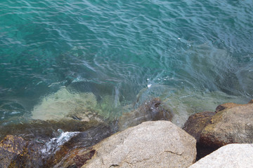 Waves hitting the rocks in the beach