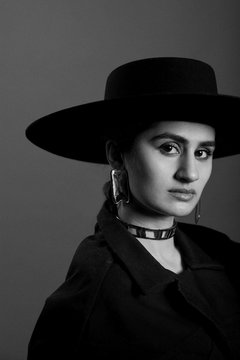 Woman in Gold Jewelry and Hat