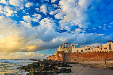 Ancient walls of the medina in Essaouira at sunset clouds