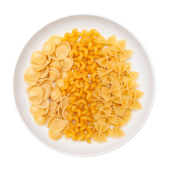 Raw pasta orecchiette, cavatappi and  farfalle in white plate or dish. Isolated