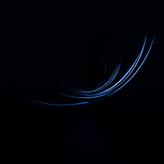 Frozen blue light in total darkness. Light blue semicircles. Abstract photography