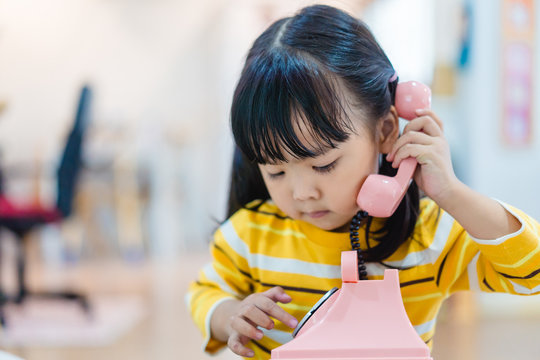 3 Years Old Little Asian Girl Holding Vintage Telephone Talking And Listening To Her Dad Or Father. Asian Child Girl Call Delivery Food Service In The Morning.Children And Vintage Technology Concept.