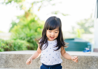 Toddler asian girl climbing and walking down the stairs at home.Concept of happy childhood and Child development.