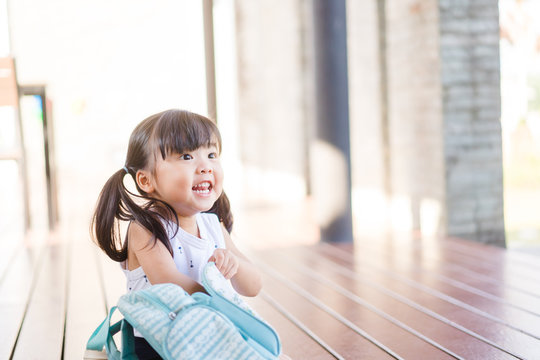 Back To School Concept.Happy Funny Little Asian Girl Preparing Bag And Very Excited And Glad When She Go Back To School.Happy Toddler Child From Kindergarten School.School Kid Girl With Bag.Education.