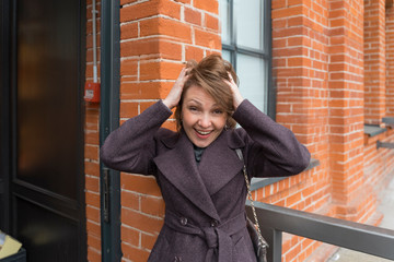 Fototapeta premium Portrait of an emotional woman. hands up, surprise, joy, delight