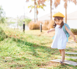 Back to School Concept.Happy Funny little toddler asian girl with big smile and very excited and glad when she go back to school.Child from elementary school kindergarten with bag.Education concept.