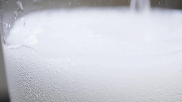 Macro shot of prosecco being poured into a glass