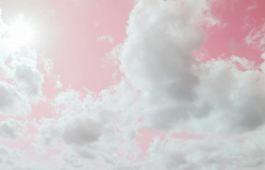 The sun is shining, the clouds and the pink sky