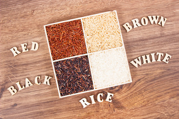 White, brown, black and red rice with inscription, healthy, gluten free nutrition concept
