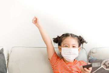 Coronavirus and Air pollution pm2.5 concept.Little chinese girl wearing mask for protect pm2.5 and...