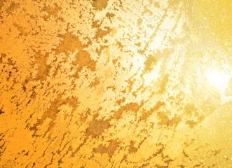 Golden glitter stars on yellow background.