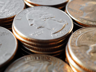Piles of US American coins of 25 cents quarters close-up. Illustration for news about the national...