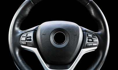 Modern car interior. Steering wheel with media phone control buttons isolated on black background....