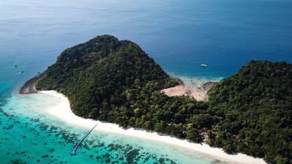 drone view of koh rok in thailand, white beach, coral reef and green jungle with turquoise ocean