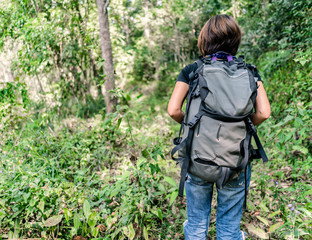 Woman backpacker hiking at the forest