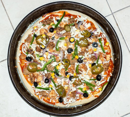 uncooked pizza in a pan