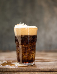Cola in glass with ice cubes.