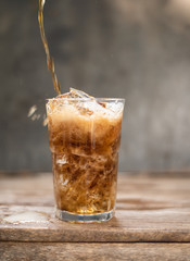 Cola in glass with ice cubes.