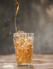 Cola in glass with ice cubes.