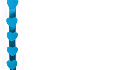 decorative blue hearts on a ribbon on a white background, isolated