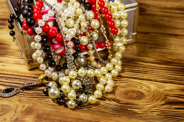 Jewelry box full of jewelry and accessories on wooden background