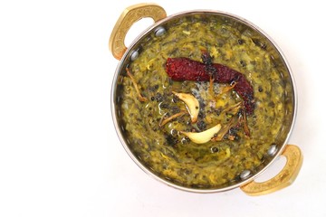 Sarson ka saag and Makke di roti. mustard leaves curry. its a popular punjabi winter dish made using corn meal & mustard leaves. served with onions and green chili in copper vessels. with copy space.
