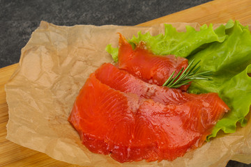 Sliced salmon fillet served rosemary