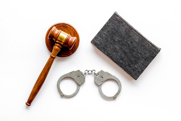 Arrest concept. Handcuffs near judge gavel on white background top-down