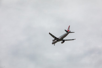 plane in sky landing overcast weather