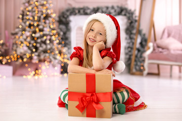 Fototapeta na wymiar Cute little child with Christmas gift at home
