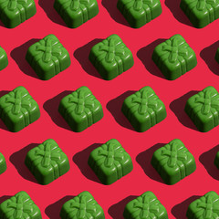 Abstract chocolate candy on coral background. Seamless patter. Background image. 