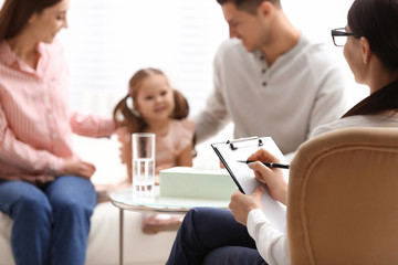 Professional psychologist working with family in office