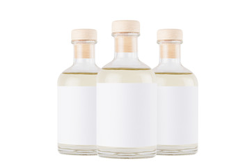 Group glass bottles for cosmetic, perfume, alcohol drink with  white label, cork, yellow liquid isolated on white background, mock up for  design.