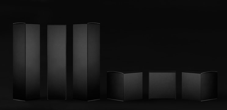 Collection of rectangle tall and square black paper boxes  - different sides on dark black background, mock up of packing product, presentation, design.
