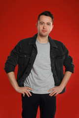 Fototapeta premium Portrait of young man on red background