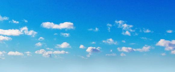 Small curly clouds in the blue sky in sunny weather_